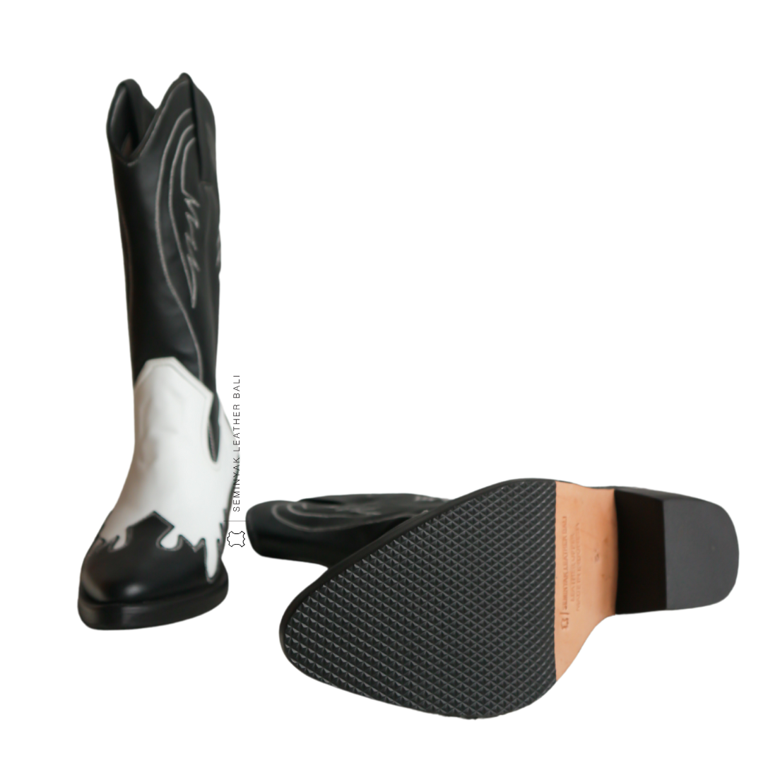 a pair of FREYA cowboy boots in black and white color, the  boots is calf high made of genuine sheep leather upper, leather sole, and 5 cm wooden heels from bottom